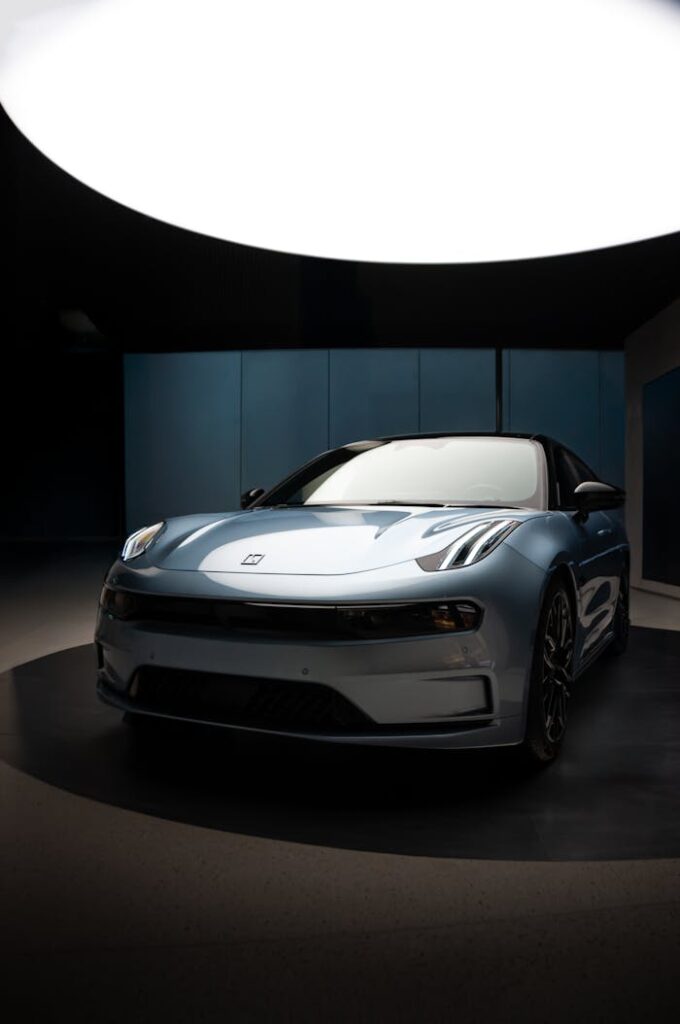 A modern blue car showcased indoors under studio lighting.