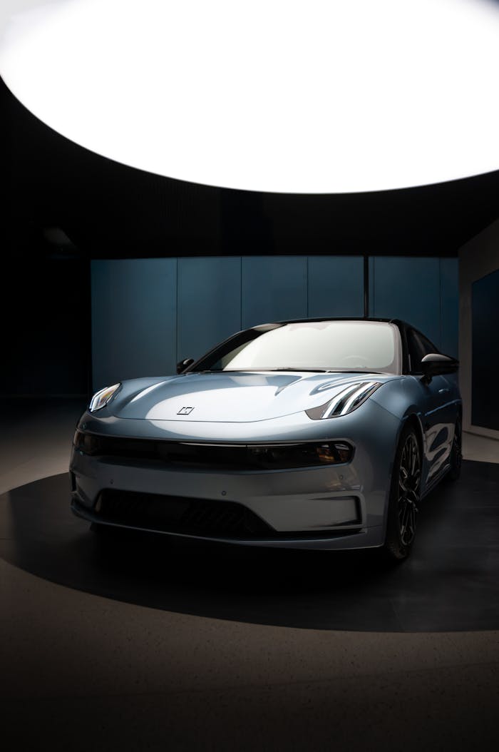 A modern blue car showcased indoors under studio lighting.